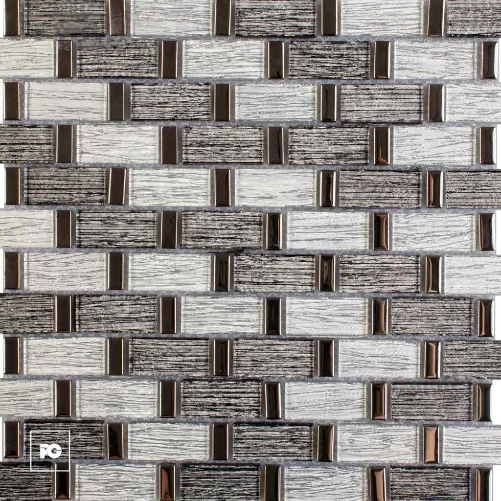 Close-up of a decorative wall tiling pattern with light and dark rectangular bricks and small bronze metal accents.